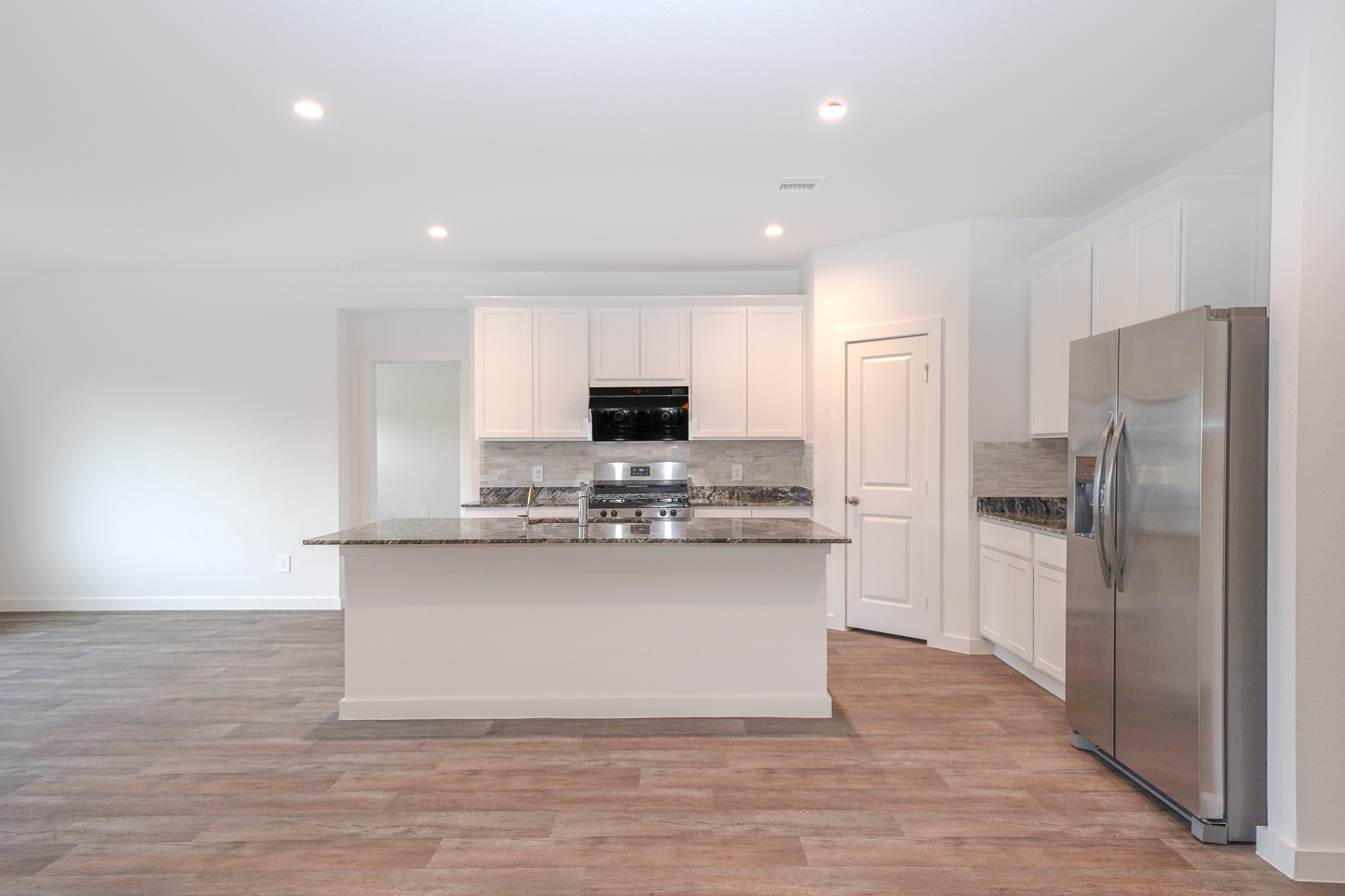 4526 Waving Willow Way Rosenberg, TX 77469 - Photo 19 of 40 a kitchen with stainless steel appliances a refrigerator and a stove top oven