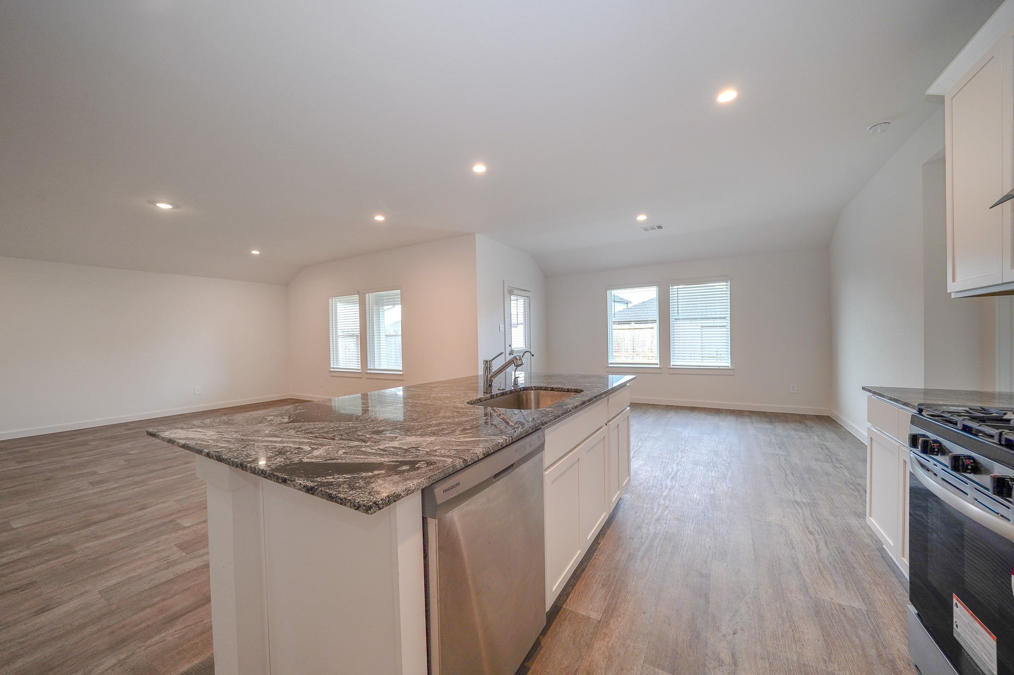 4526 Waving Willow Way Rosenberg, TX 77469 - Photo 23 of 40 a kitchen with granite countertop sink stove and cabinets