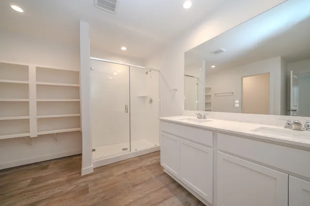 a bathroom with a double vanity sink and a mirror