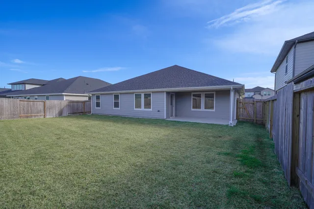a view of a yard with a house in the background