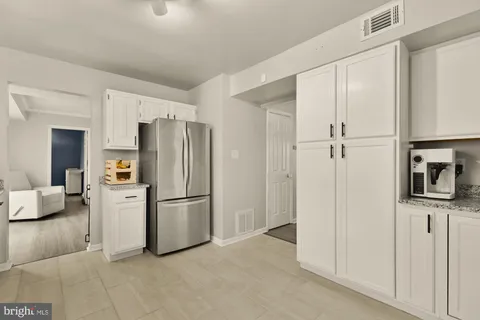 a kitchen with stainless steel appliances a refrigerator sink and cabinets
