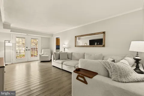a living room with furniture and a lamp