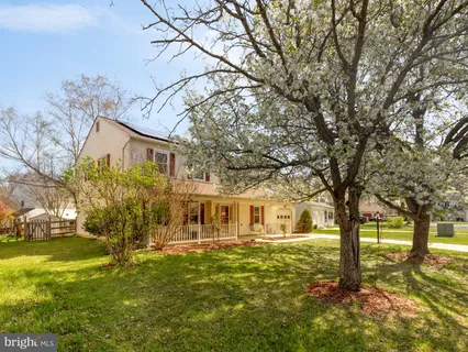 a front view of a house with yard and green space