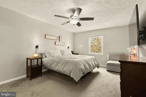 a spacious bedroom with a bed and a window