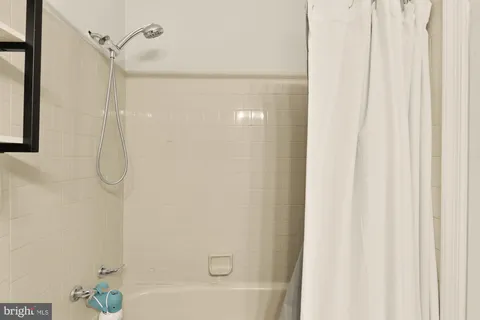 a view of a patio with a table and chairs under an umbrella with wooden fence