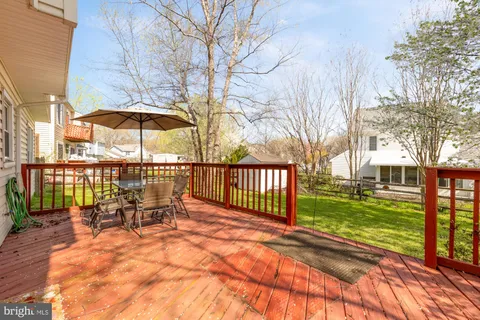 a view of a patio with a table and chairs under an umbrella