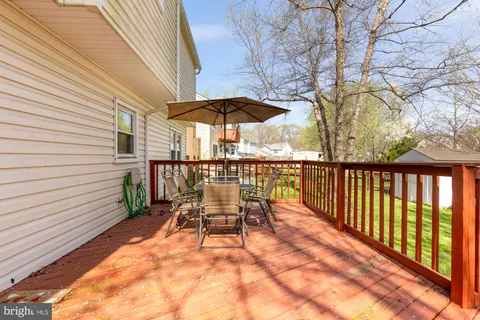 a backyard of a house with barbeque oven table and chairs