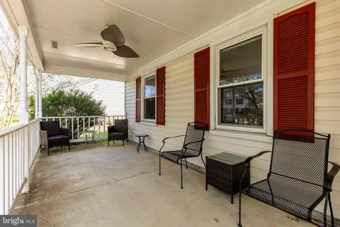 a view of a porch with furniture and a gate