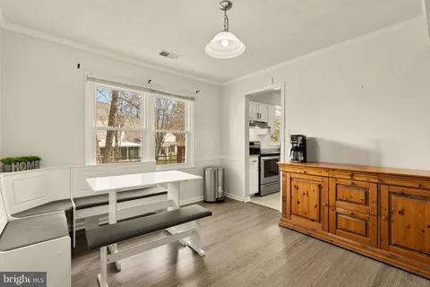 a large white kitchen with granite countertop a large window