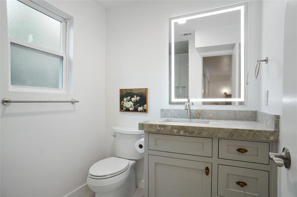 2147 Chaparral Gainesville, TX 76240 - Photo 21 of 40 a bathroom with a granite countertop toilet sink and mirror