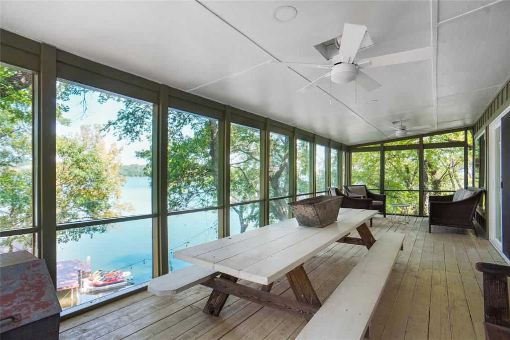 2147 Chaparral Gainesville, TX 76240 - Photo 30 of 40 a living room with large windows and wooden floor