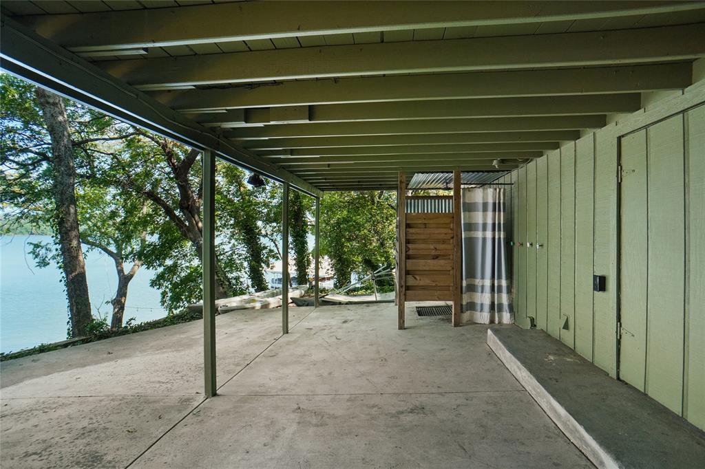 2147 Chaparral Gainesville, TX 76240 - Photo 32 of 40 a view of an empty room with wooden stairs and a large window