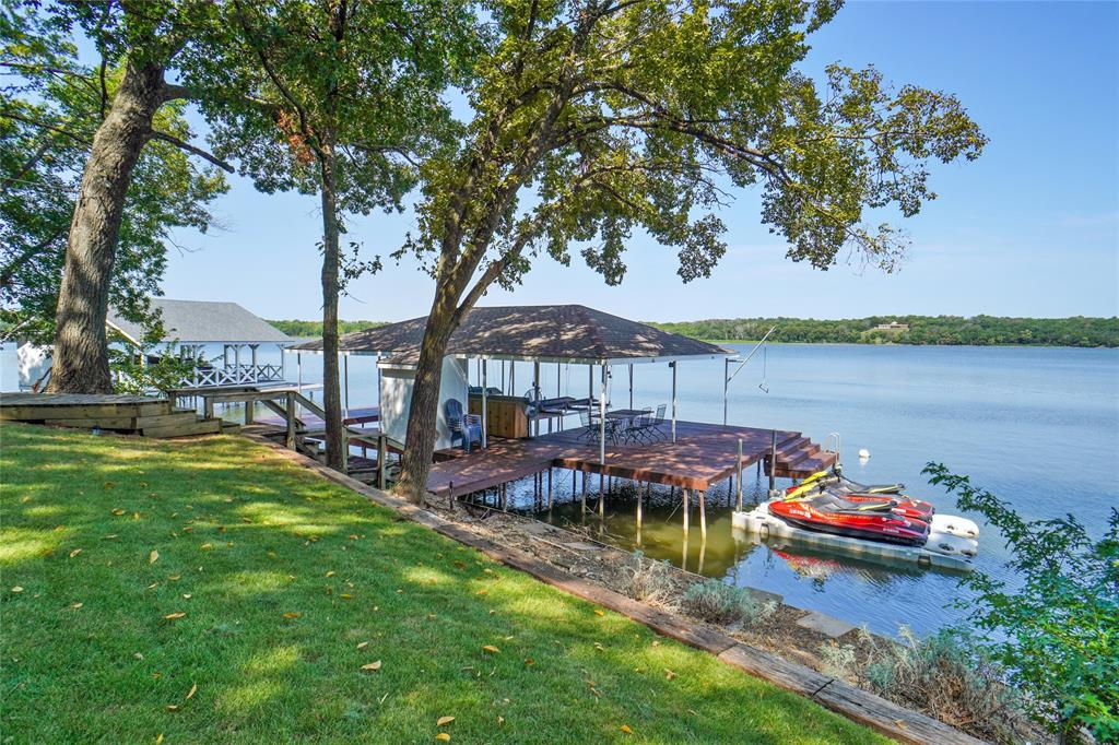 2147 Chaparral Gainesville, TX 76240 - Photo 36 of 40 a backyard of a house with lots of green space and lake view