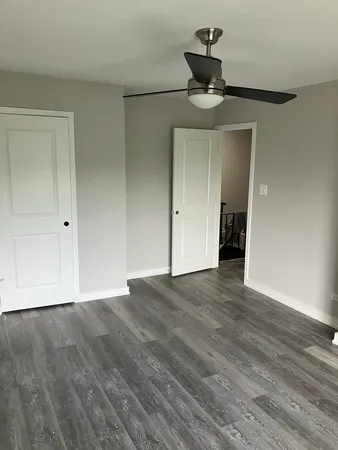 a view of an empty room and wooden floor