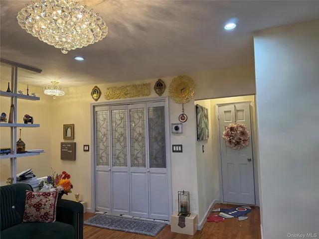 a bed room with a bed and a chandelier