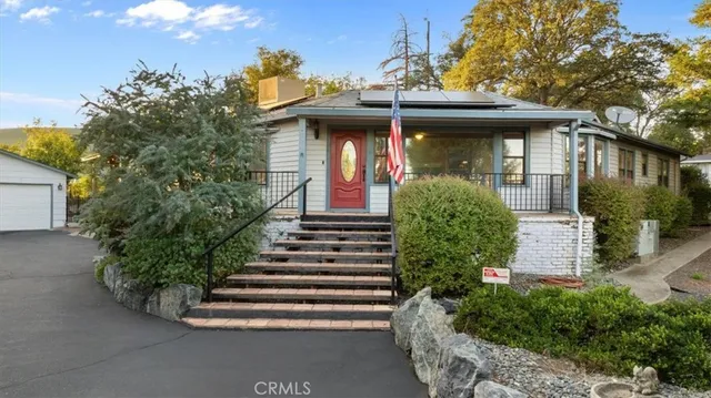 a front view of a house with a garden