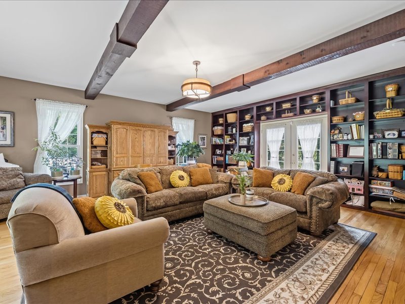 1168 Mt Pleasant Road Bangor, PA 18013 - Photo 62 of 100 Rich wood flooring pairs beautifully with handsome ceiling beams in this inviting living space.