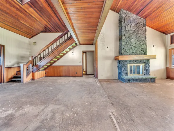a view of an empty room with a fireplace