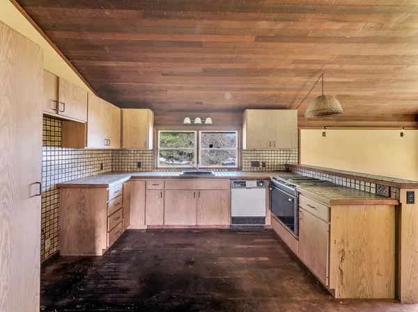 a kitchen with granite countertop white cabinets and white appliances