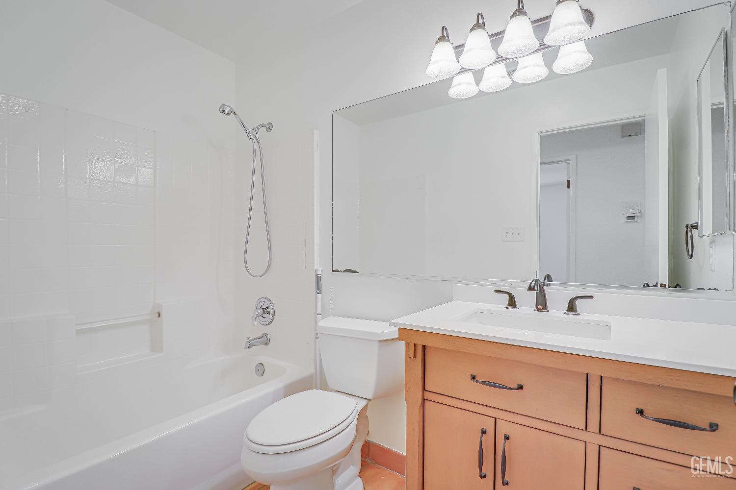 Undisclosed Address Bakersfield, CA 93312 - Photo 15 of 24 a bathroom with a sink a toilet and a large mirror