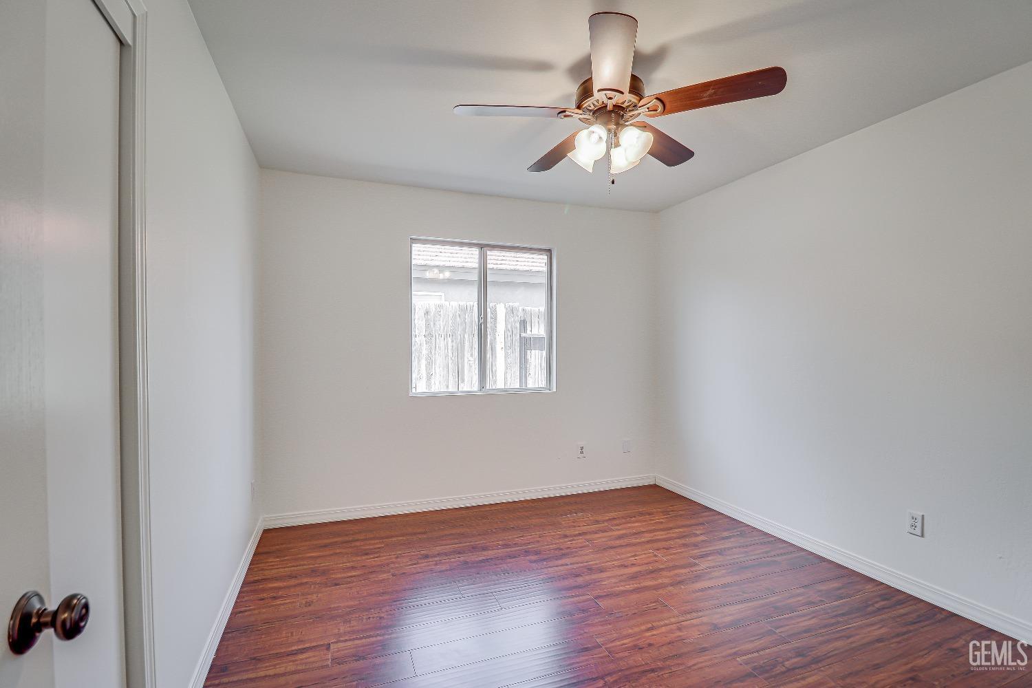 Undisclosed Address Bakersfield, CA 93312 - Photo 16 of 24 wooden floor in an empty room with a window