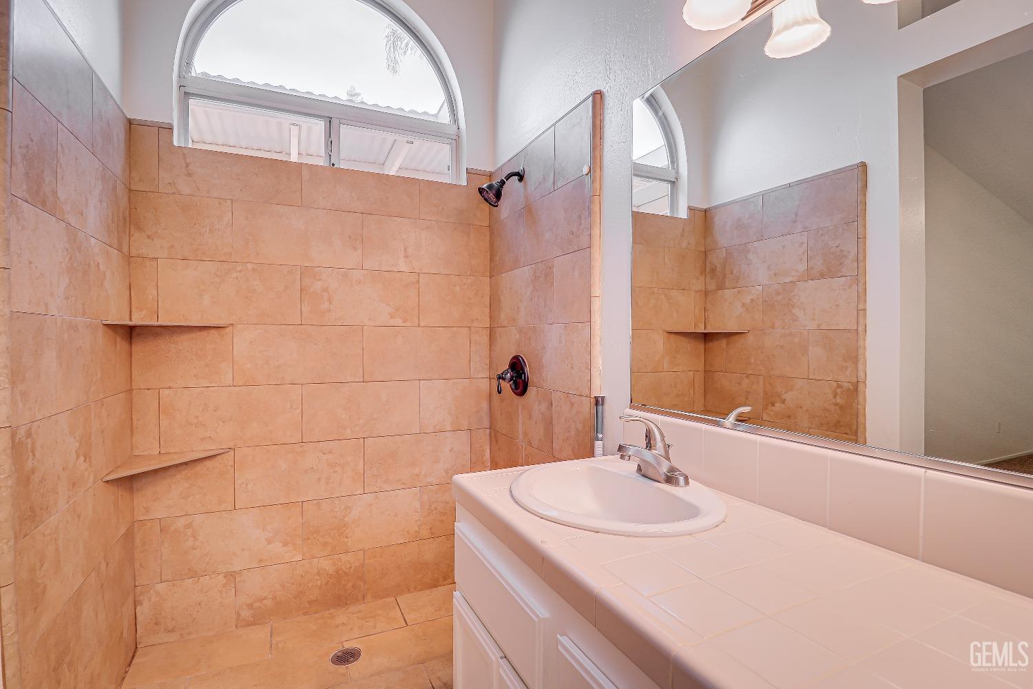 Undisclosed Address Bakersfield, CA 93312 - Photo 19 of 24 a bathroom with a sink and a mirror
