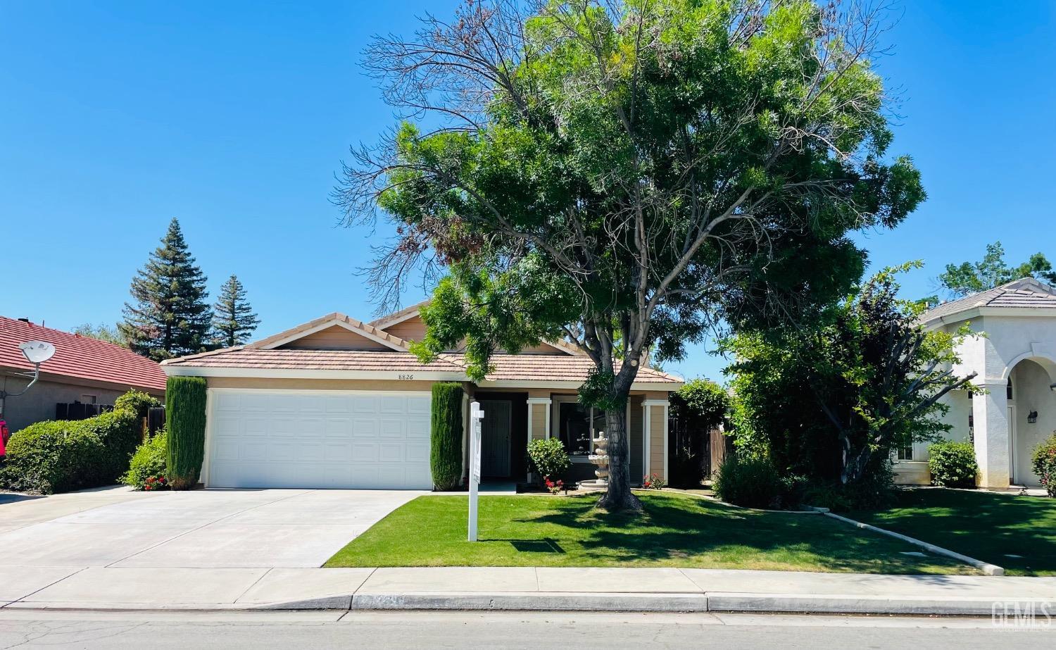 Undisclosed Address Bakersfield, CA 93312 - Photo 2 of 24 a front view of a house with a yard and trees