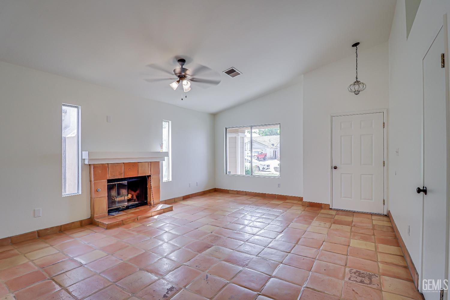 Undisclosed Address Bakersfield, CA 93312 - Photo 5 of 24 a view of empty room with fireplace and fan