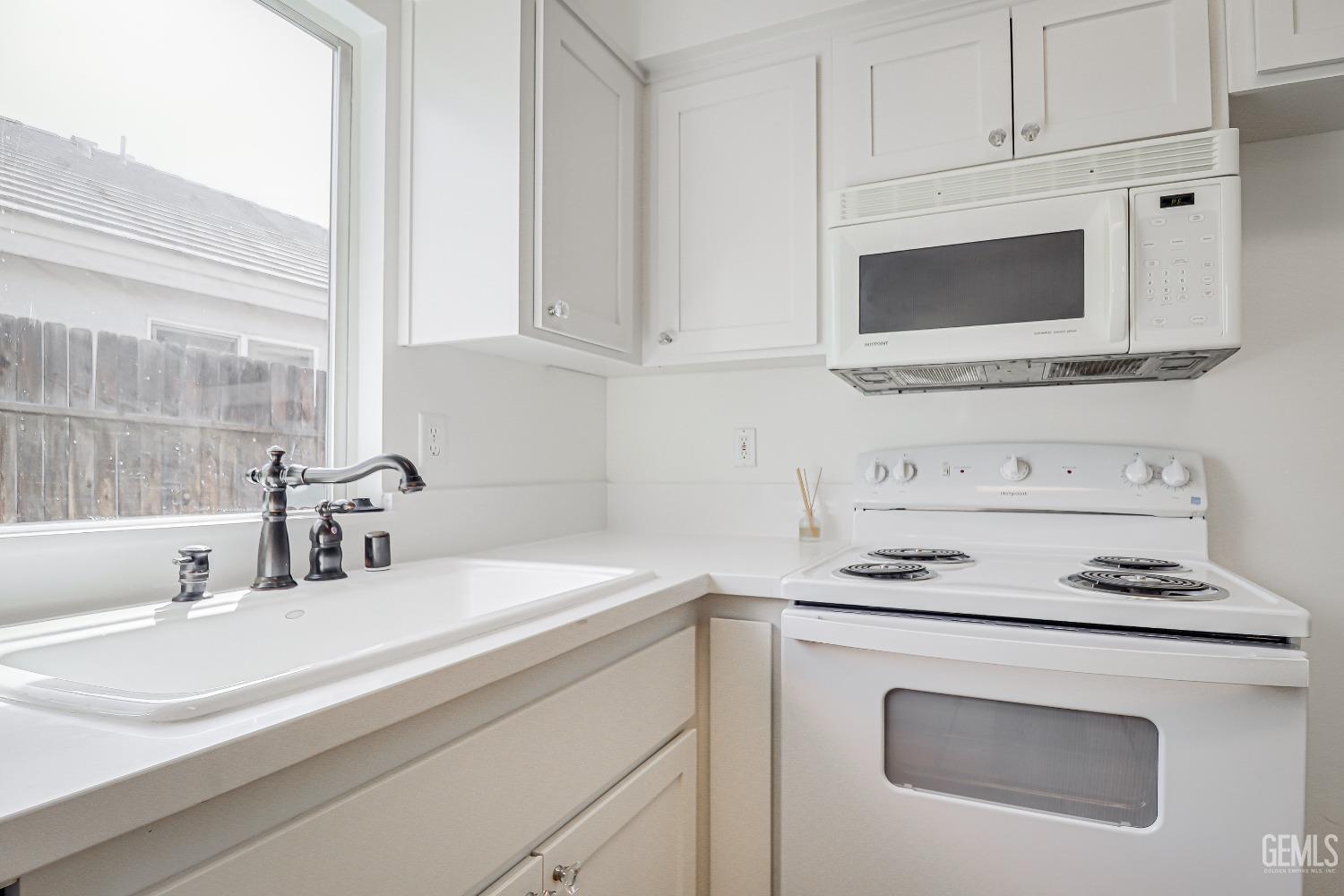 Undisclosed Address Bakersfield, CA 93312 - Photo 9 of 24 a kitchen with stainless steel appliances white cabinets and a sink