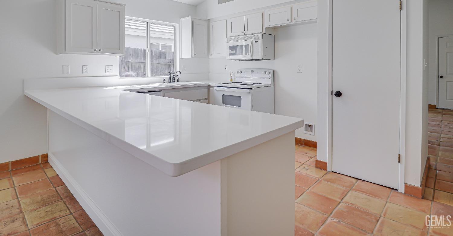Undisclosed Address Bakersfield, CA 93312 - Photo 10 of 24 a utility room with cabinets washer and dryer
