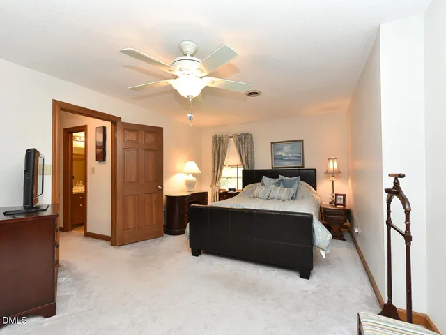 a bed room with a bed and a chandelier