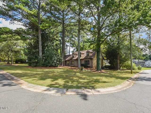 a view of a swimming pool with a house in the background