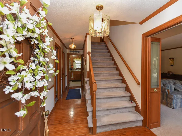 a view of entryway and hall with wooden floor