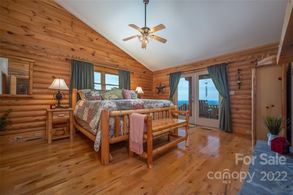 175 Big Rock Road Bostic, NC 28018 - Photo 25 of 45 a bedroom with a bed and a chandelier