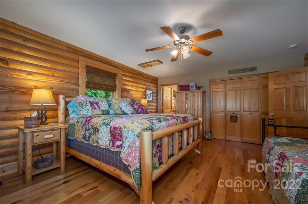 175 Big Rock Road Bostic, NC 28018 - Photo 32 of 45 a bedroom with a bed and a chandelier