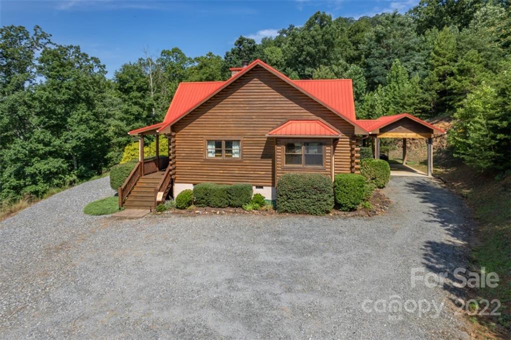175 Big Rock Road Bostic, NC 28018 - Photo 7 of 45 a front view of a house with a yard and garage