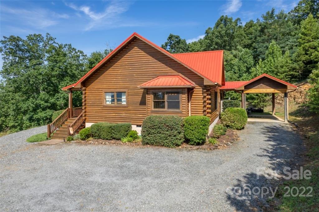 175 Big Rock Road Bostic, NC 28018 - Photo 8 of 45 a front view of a house with a yard and garage