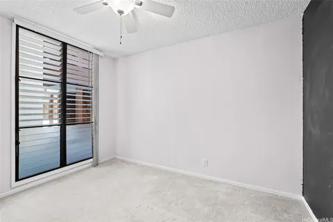 a view of empty room with ceiling fan