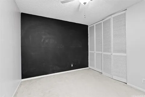 a view of an empty room with a ceiling fan