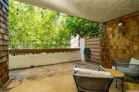 a balcony with table and chairs