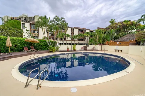a view of swimming pool with outdoor seating and plants