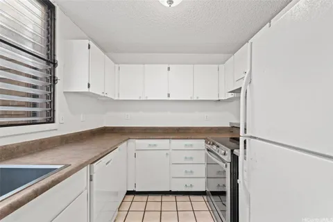 a kitchen with cabinets appliances and a sink