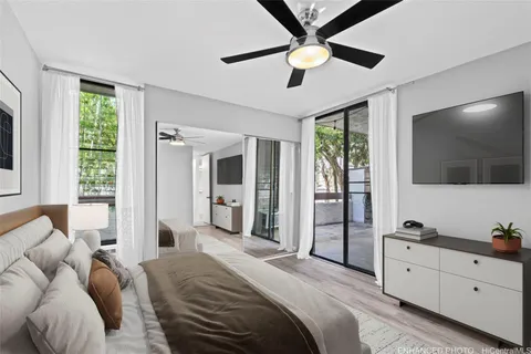 a spacious bedroom with a large bed and a flat screen tv