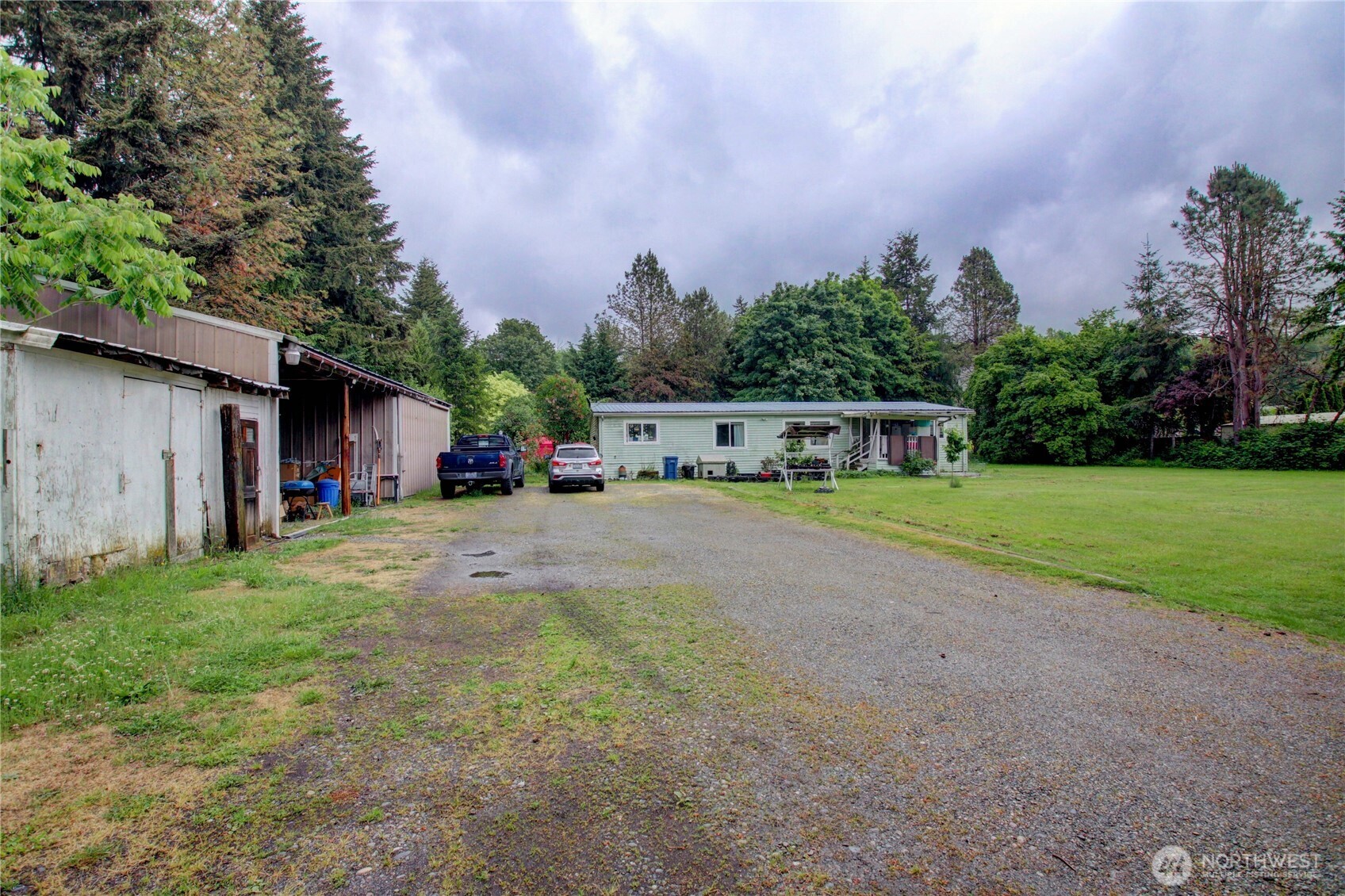 7185 Old Highway 99 North Road Burlington, WA 98233 - Photo 6 of 26 a view of a house with backyard and a garden