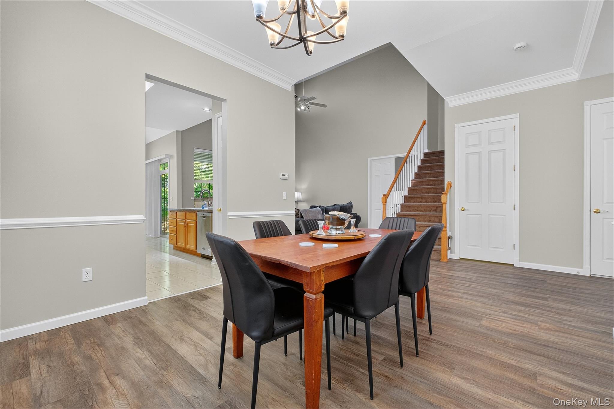 146 Stony Brook Road Fishkill, NY 12524 - Photo 3 of 12 Dining space with stairway, a chandelier, crown molding, and light wood finished floors