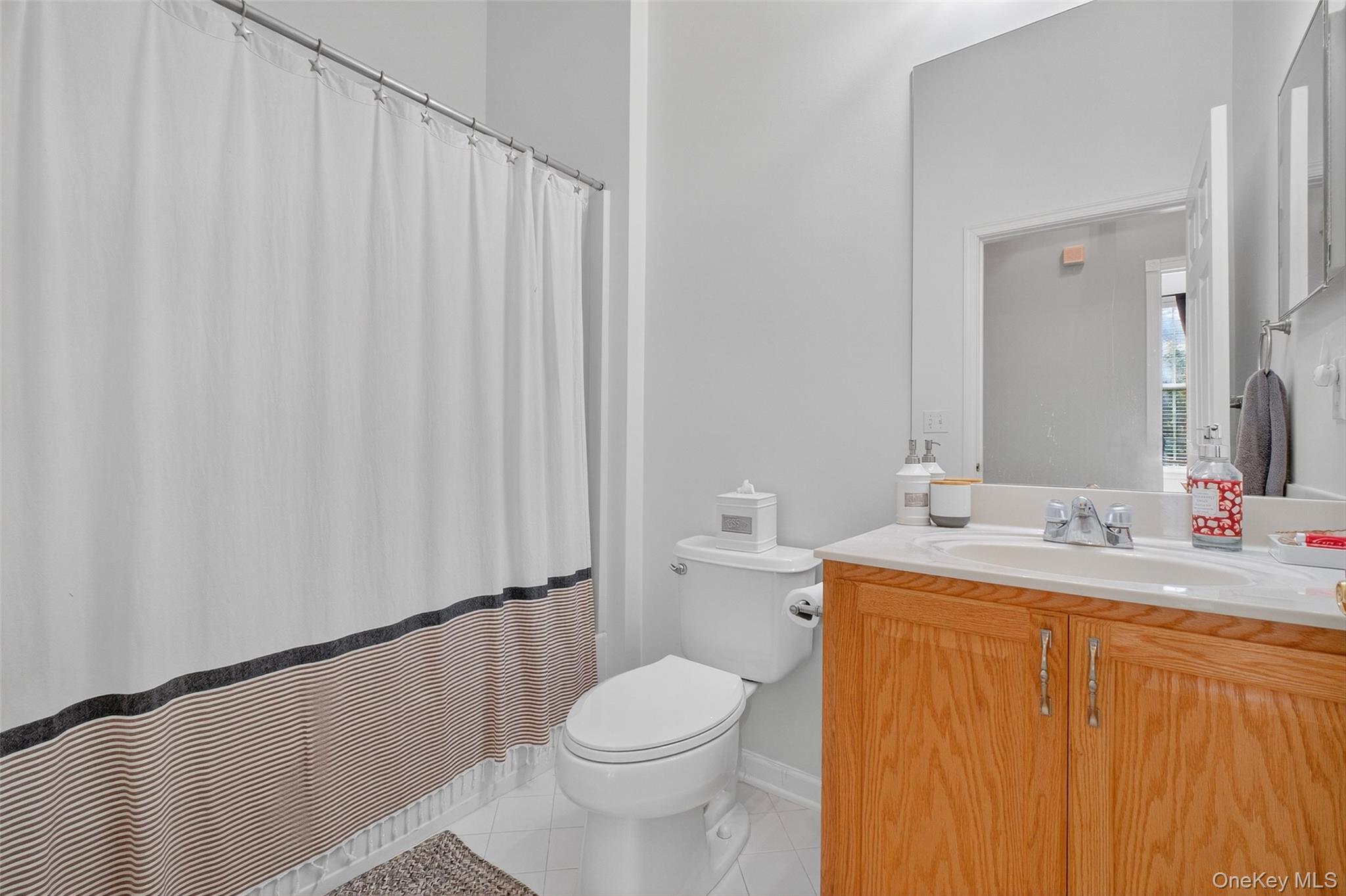 146 Stony Brook Road Fishkill, NY 12524 - Photo 10 of 12 Bathroom with light tile patterned floors, a shower with curtain, and vanity