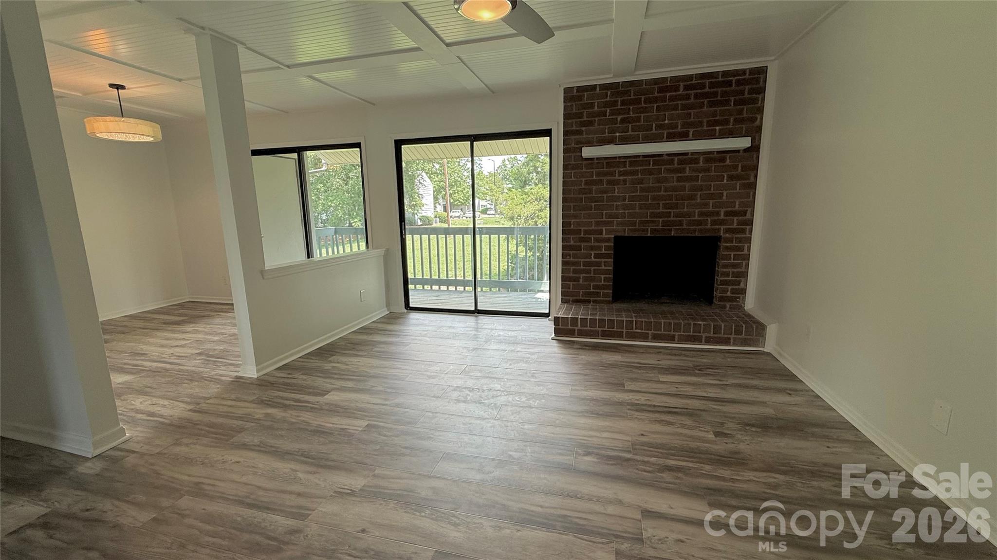 11023 Harrowfield Road Charlotte, NC 28226 - Photo 7 of 32 a view of a livingroom with wooden floor and a fireplace
