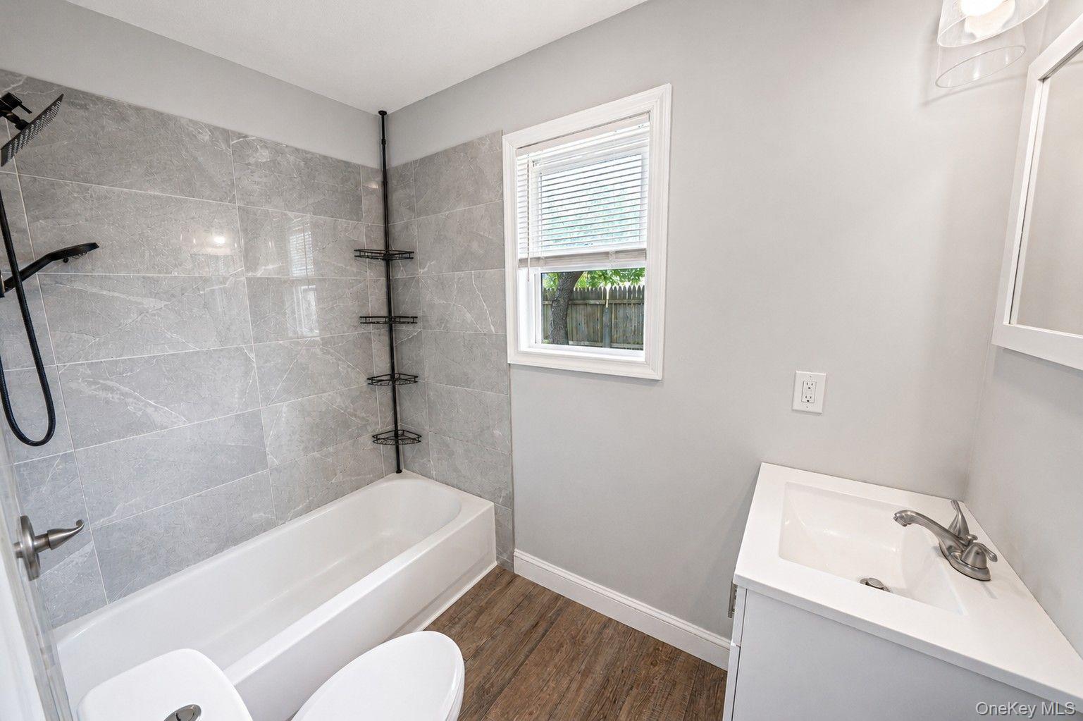 332 Commack Road Shirley, NY 11967 - Photo 19 of 25 a bathroom with a sink a toilet and shower