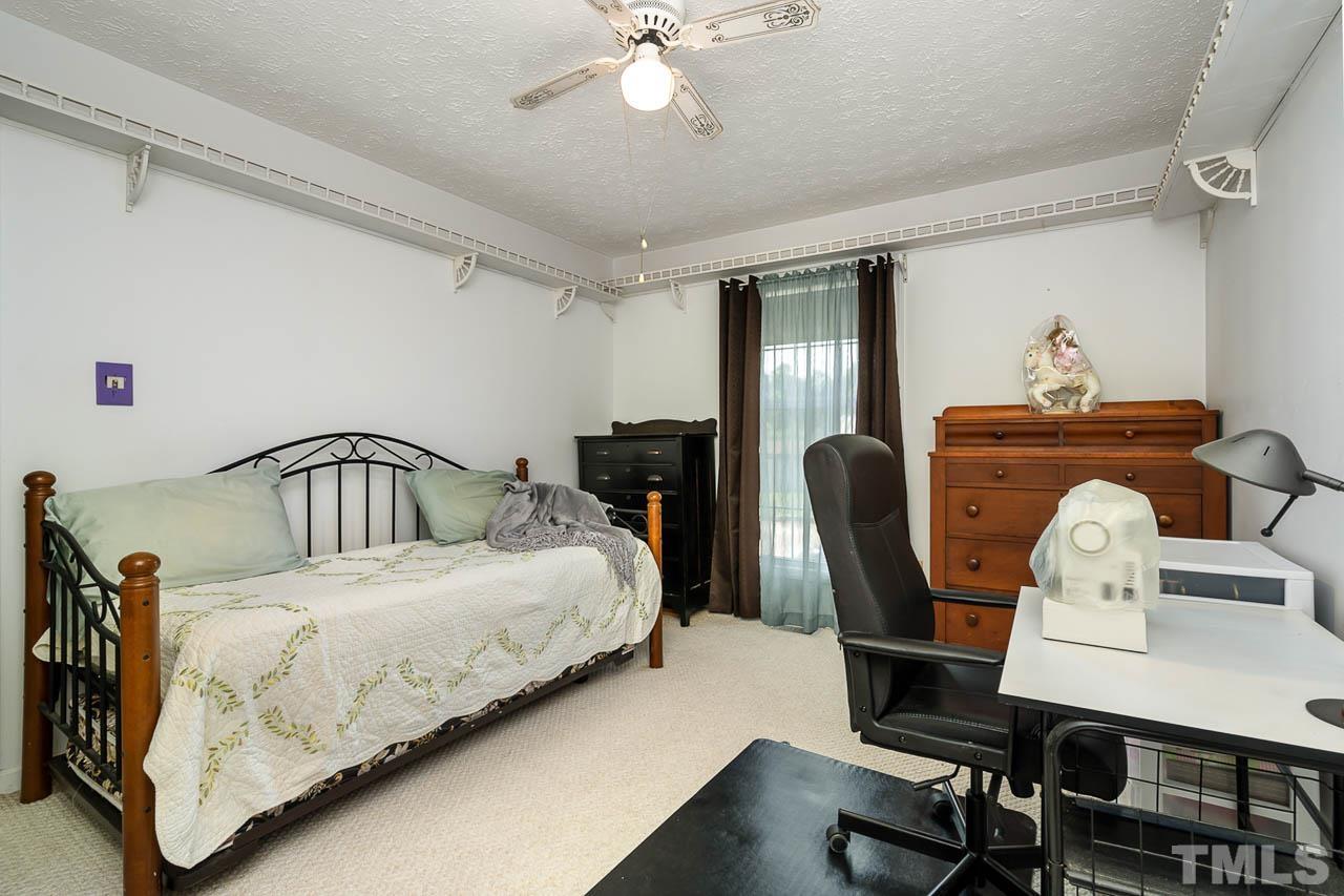 3255 Walters Road Creedmoor, NC 27522 - Photo 11 of 19 a bedroom with a bed wooden floor and a desk
