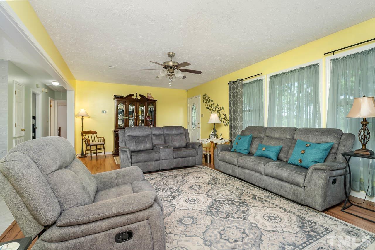 3255 Walters Road Creedmoor, NC 27522 - Photo 3 of 19 a living room with furniture and a chandelier